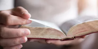 close up of someone reading a bible